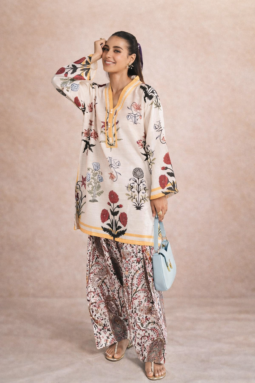 Woman wearing a floral embroidered outfit with a beige background