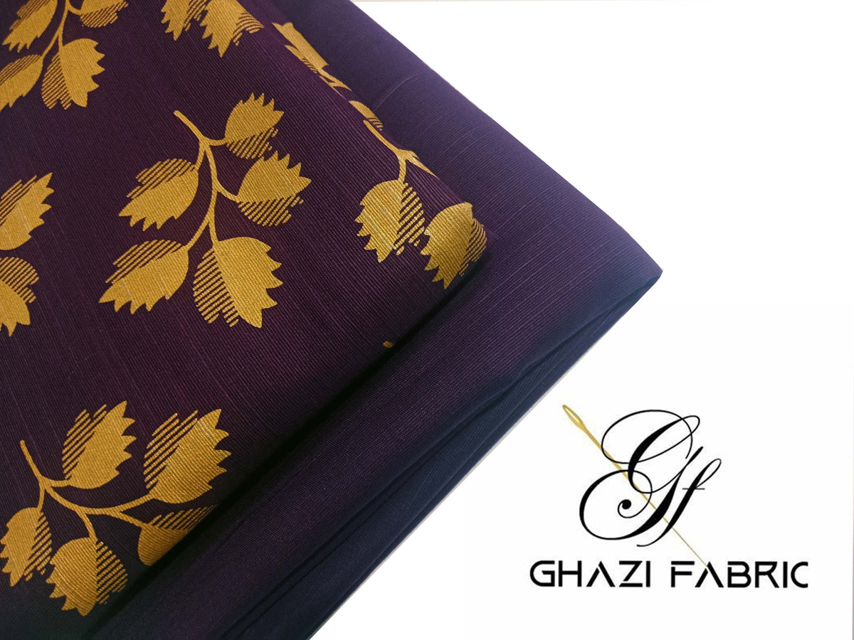 Purple fabric with gold floral patterns and Ghazi Fabric logo.