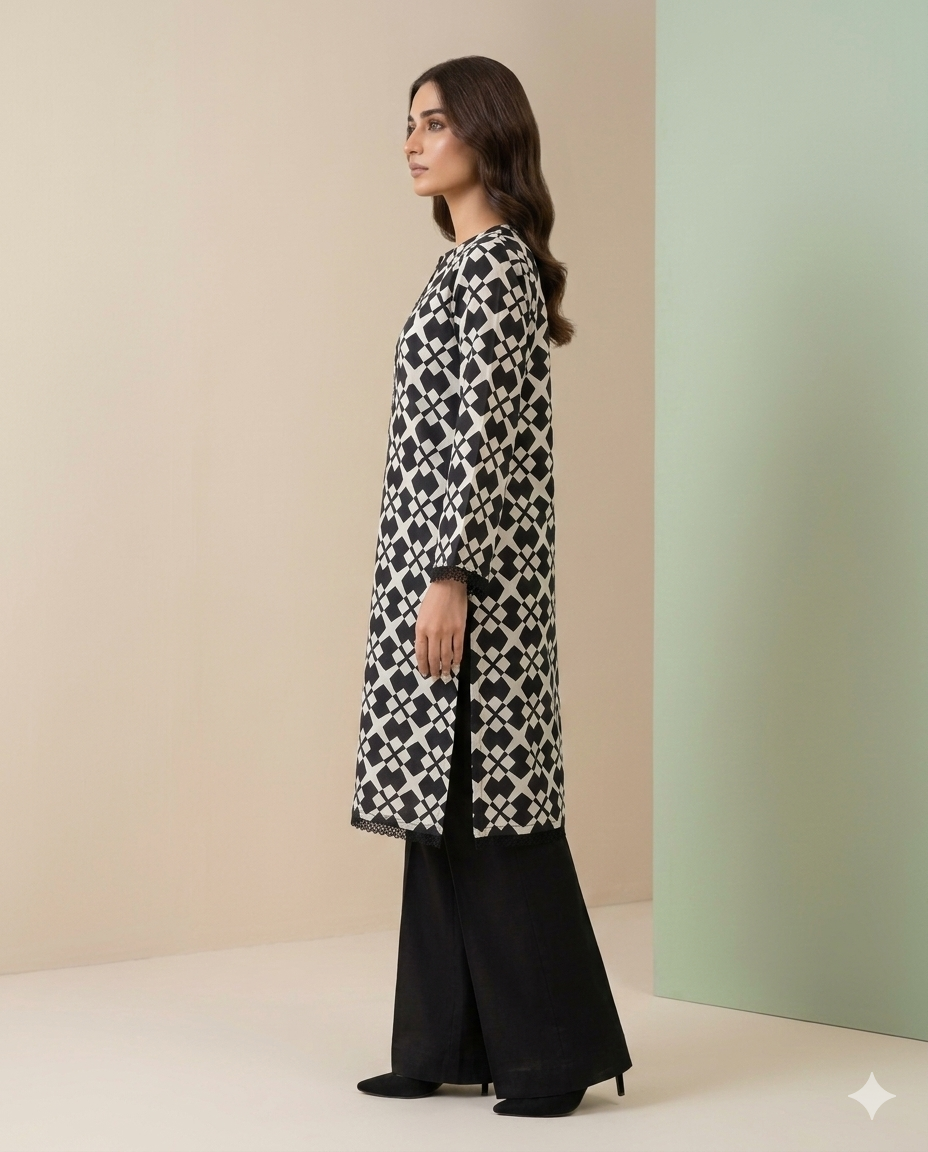 Woman wearing a black and white patterned long shirt with black pants against a beige and green background