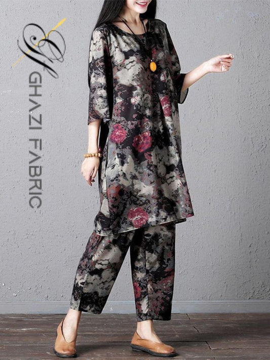 Woman wearing a floral outfit with 'Ghazi Fabric' logo on a gray background